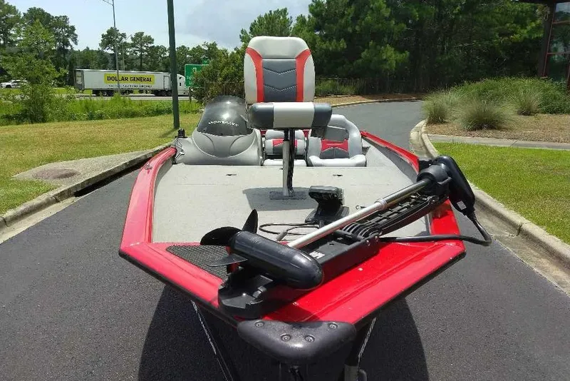 Slide: The Image of 2009 Tracker Pro Team 175 TXW boat with red trim, parked on a road. - 9