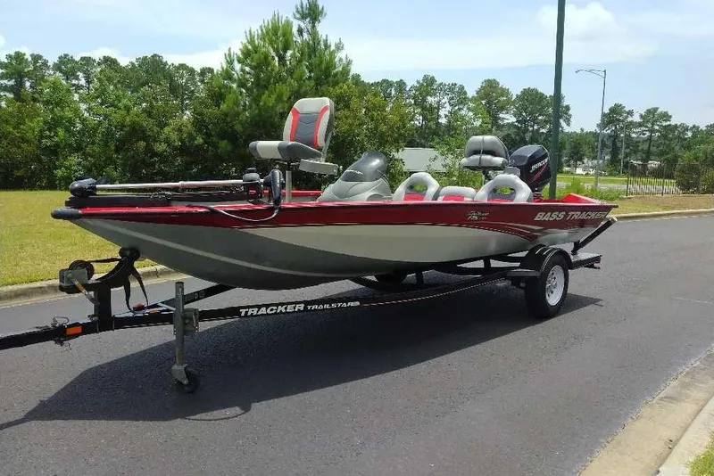 Slide: The Image of 2009 Tracker Pro Team 175 TXW boat on trailer, parked on a road with trees in background. - 11