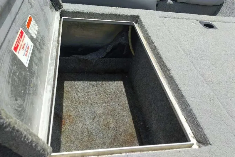 Slide: The Image of Open storage compartment on a 2009 Tracker Pro Team 175 TXW boat. - 7