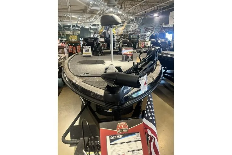 Slide: The Image of 2026 Nitro Z19 XL boat displayed indoors with sale sign and American flag. - 5