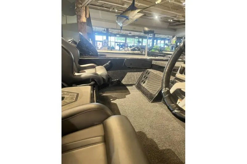 Slide: The Image of Interior view of 2026 Nitro Z19 XL boat, showcasing seating and steering area. - 6