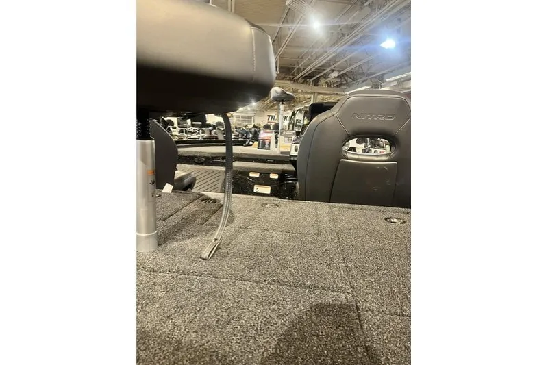 Slide: The Image of 2026 Nitro Z19 XL boat interior with cushioned seating and carpeted flooring. - 7