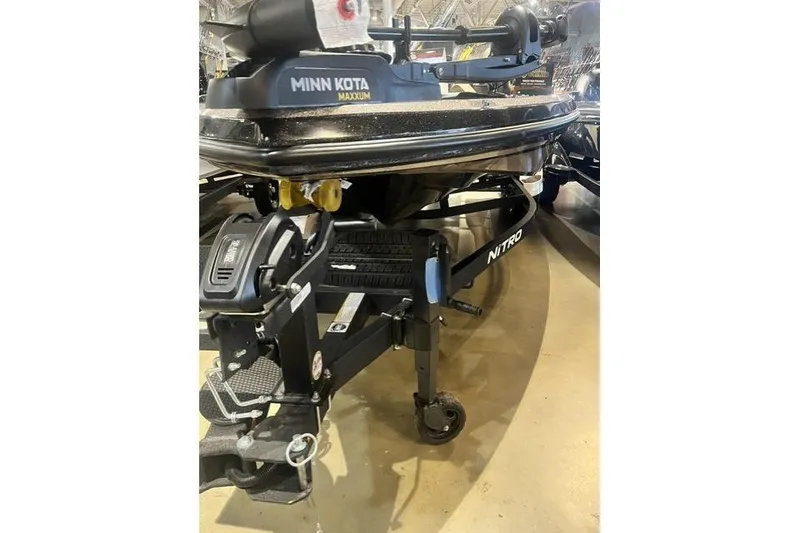 Slide: The Image of 2026 Nitro Z19 XL boat with Minn Kota Maxxum trolling motor displayed indoors. - 12
