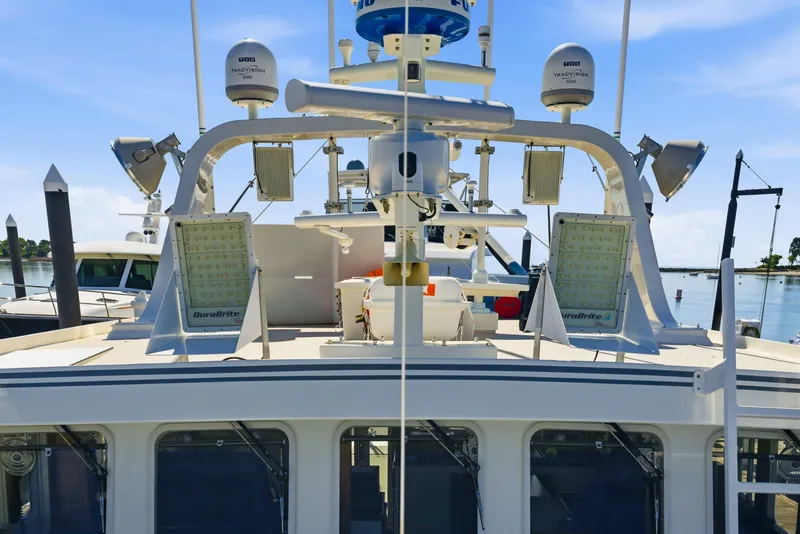 Slide: The Image of Dixon 55 boat, 2018 model, featuring advanced navigation and communication equipment at a marina. - 18