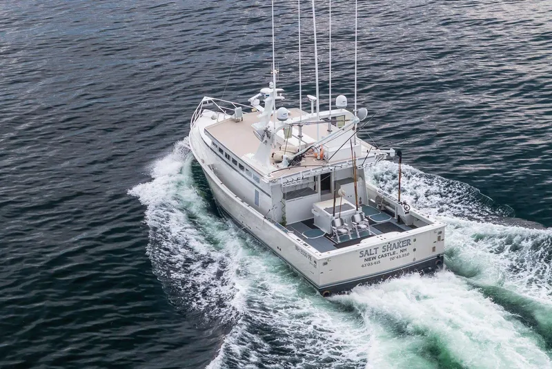 Slide: The Image of Aerial view of 2018 Dixon 55 boat cruising on open water. - 15