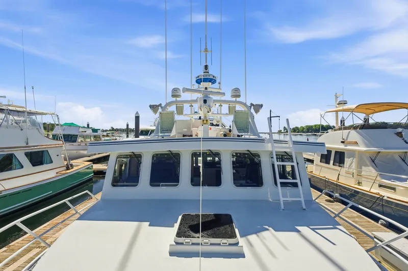 Slide: The Image of 2018 Dixon 55 yacht docked at marina under clear blue sky. - 19