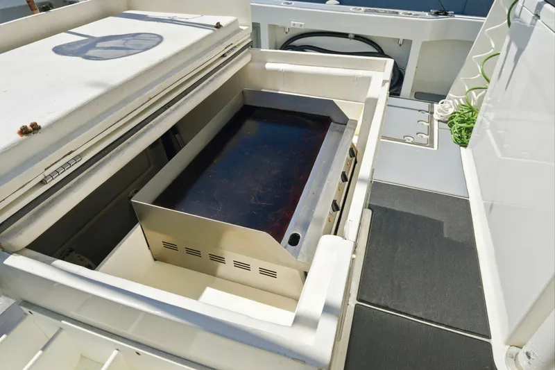 Slide: The Image of Outdoor grill on a 2018 Dixon 55 yacht deck, featuring a sleek stainless steel design. - 64