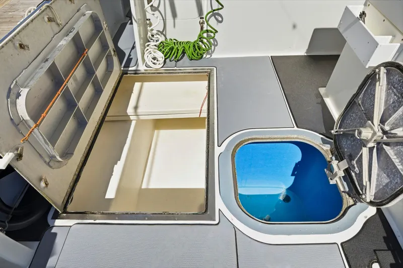 Slide: The Image of Open storage compartments on a 2018 Dixon 55 boat deck. - 61