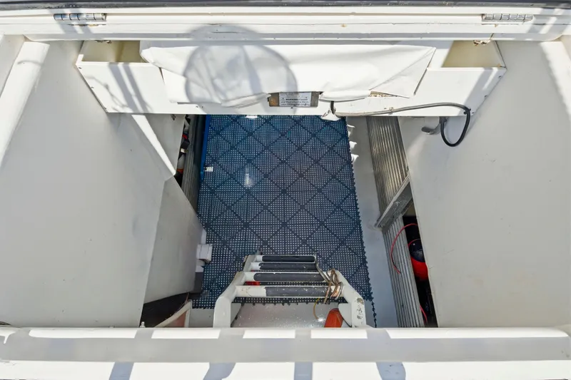 Slide: The Image of Interior view of a 2018 Dixon 55 boat, featuring a blue patterned floor. - 58