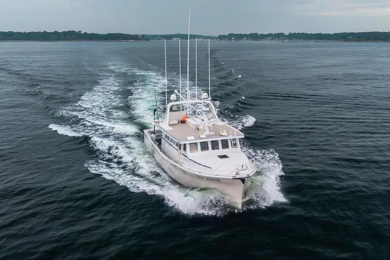 Slide: The Image of Aerial view of 2018 Dixon 55 boat cruising on open water. - 16