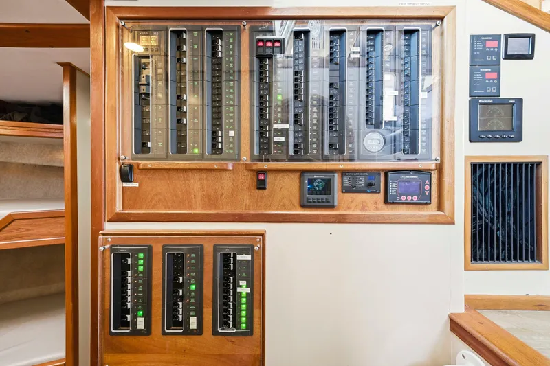Slide: The Image of Electrical control panel on a 2018 Dixon 55 yacht, featuring switches and displays. - 35
