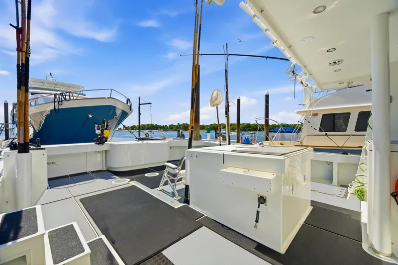Slide: The Image of Spacious deck of a 2018 Dixon 55 yacht, docked with clear blue skies. - 53