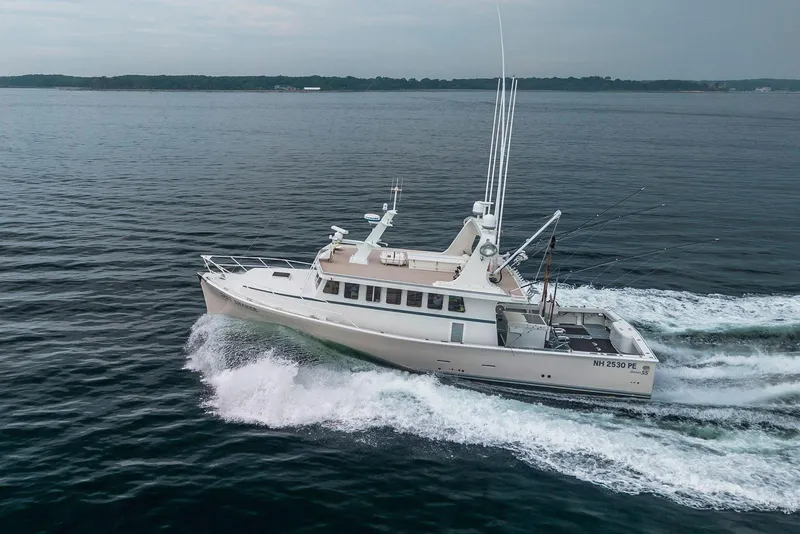 Slide: The Image of A 2018 Dixon 55 yacht cruising on open water, showcasing sleek design and performance. - 0
