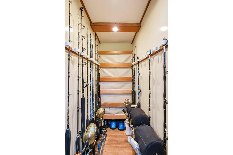 Slide: The Image of Fishing rod storage room on a 2018 Dixon 55 yacht, featuring organized racks and equipment. - 36