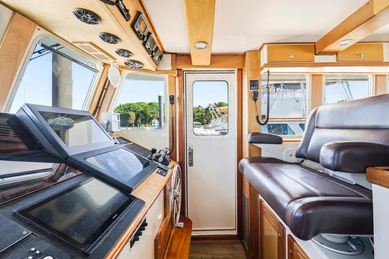 Slide: The Image of Interior of a 2018 Dixon 55 boat with modern navigation equipment and seating. - 34