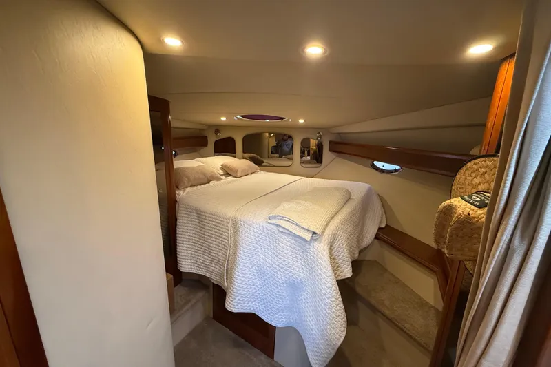 Slide: The Image of Luxurious cabin interior of 2006 Cruisers Yachts 370 Express with cozy bedding and ambient lighting. - 32