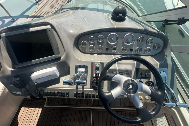 Slide: The Image of Helm of 2006 Cruisers Yachts 370 Express with steering wheel and control panel. - 7