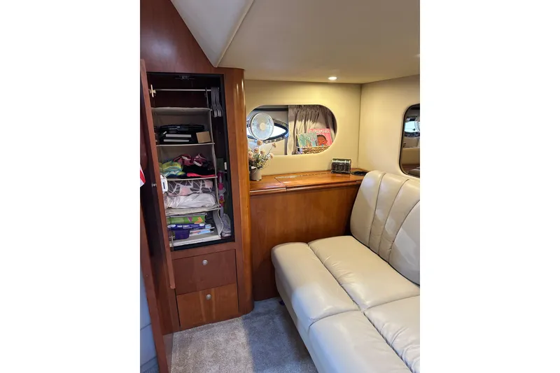 Slide: The Image of Interior of 2006 Cruisers Yachts 370 Express with beige seating and wooden cabinetry. - 30