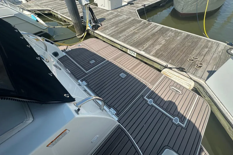 Slide: The Image of 2006 Cruisers Yachts 370 Express docked, featuring sleek deck design and mooring details. - 17