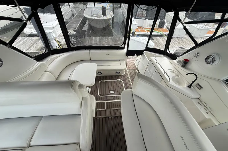 Slide: The Image of Luxurious interior of 2006 Cruisers Yachts 370 Express with white seating and kitchenette. - 14