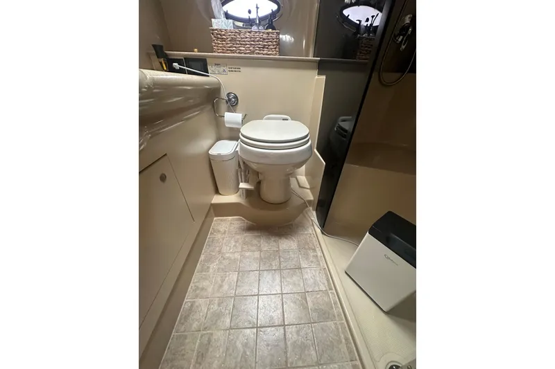 Slide: The Image of Bathroom interior of 2006 Cruisers Yachts 370 Express, featuring toilet and shower area. - 42