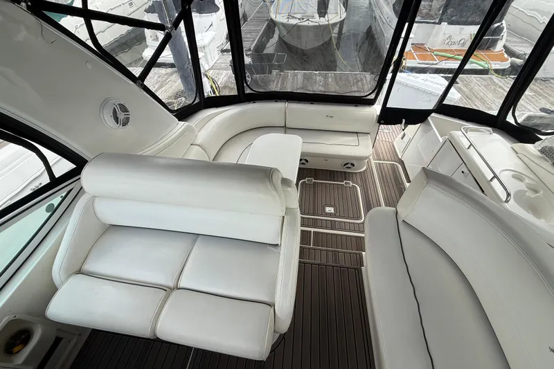 Slide: The Image of Interior of 2006 Cruisers Yachts 370 Express with white seating and wood flooring. - 6