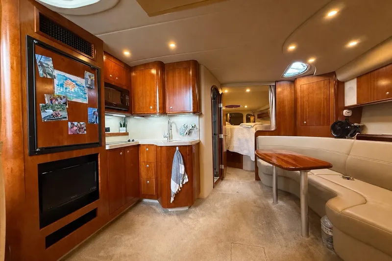 Slide: The Image of Luxurious 2006 Cruisers Yachts 370 Express interior with wood cabinetry and cozy seating area. - 23