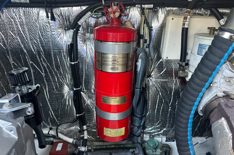 Slide: The Image of Engine room of 2006 Cruisers Yachts 370 Express with fire extinguisher and wiring. - 49
