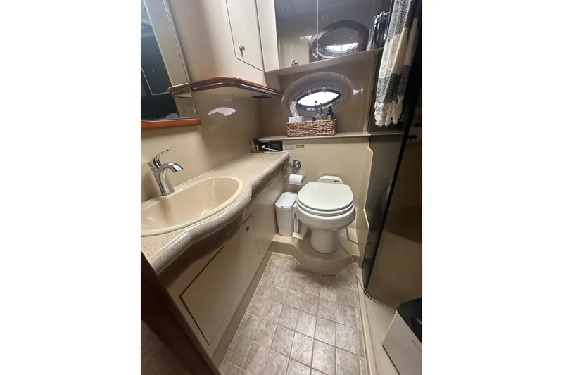 Slide: The Image of Bathroom interior of 2006 Cruisers Yachts 370 Express, featuring sink, toilet, and storage. - 40