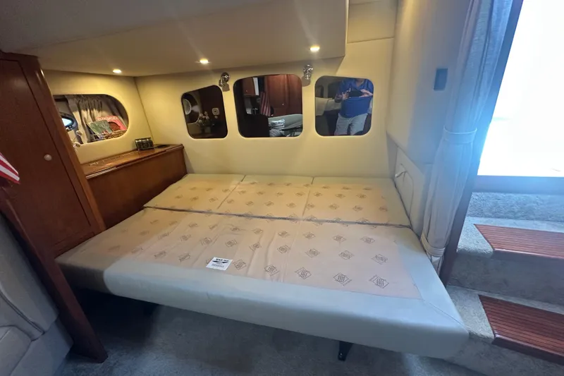 Slide: The Image of Interior cabin of 2006 Cruisers Yachts 370 Express with bed and wooden cabinetry. - 31