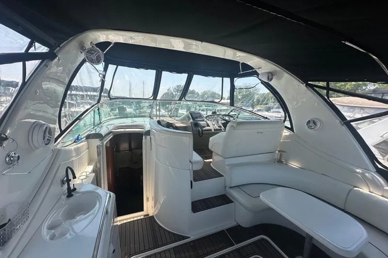 Slide: The Image of Interior of 2006 Cruisers Yachts 370 Express, featuring helm, seating, and sink. - 18