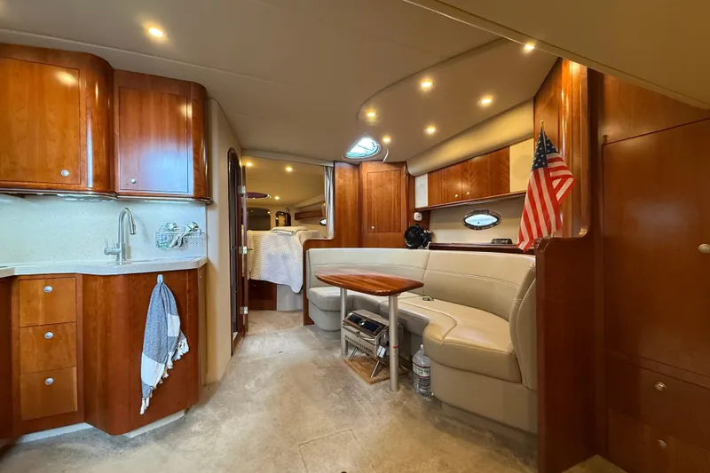 Slide: The Image of Luxurious 2006 Cruisers Yachts 370 Express interior with wood cabinetry and cozy seating area. - 24
