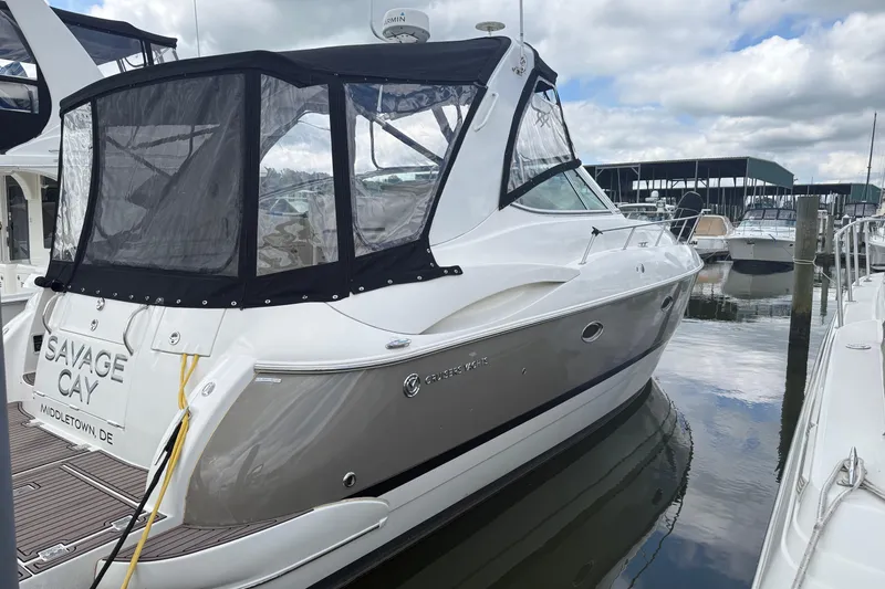 Slide: The Image of 2006 Cruisers Yachts 370 Express docked at marina under cloudy sky. - 4