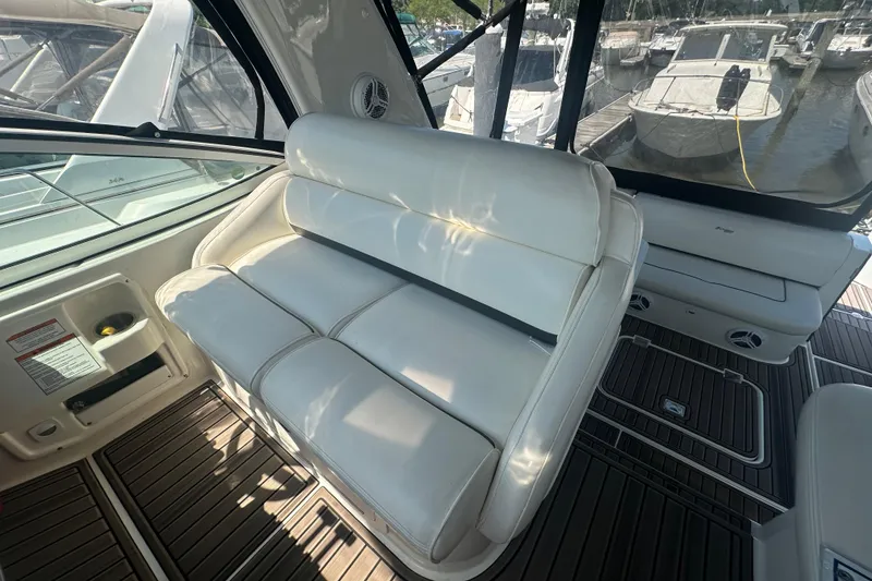 Slide: The Image of Interior of 2006 Cruisers Yachts 370 Express with white seating and wood flooring. - 11