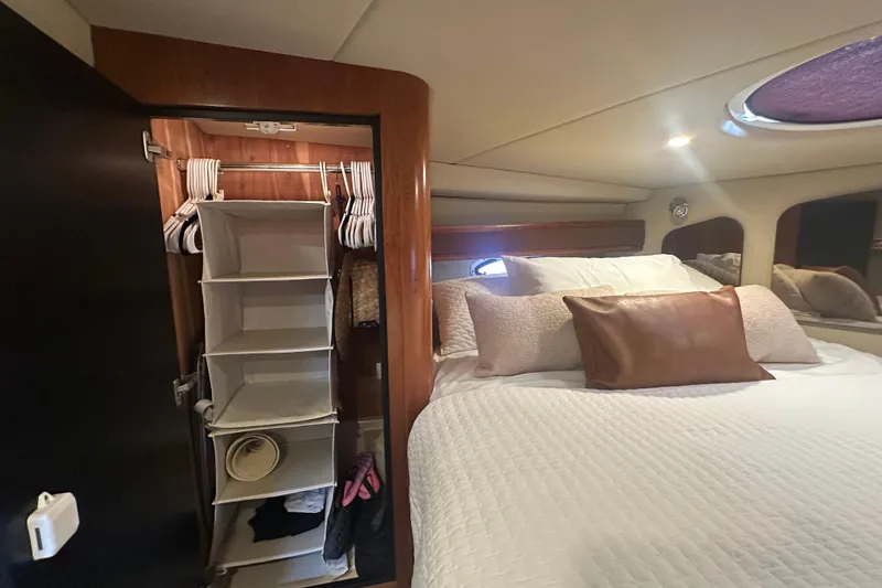 Slide: The Image of Interior of 2006 Cruisers Yachts 370 Express with cozy bed and organized closet. - 34