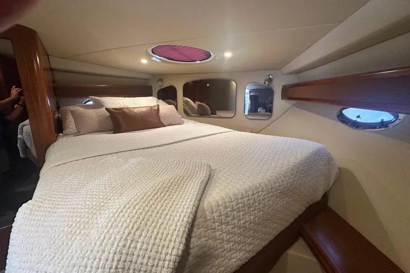 Slide: The Image of Luxurious cabin interior of 2006 Cruisers Yachts 370 Express with cozy bedding. - 35