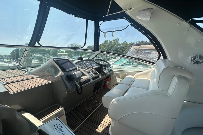 Slide: The Image of Interior of 2006 Cruisers Yachts 370 Express with helm and white seating. - 9