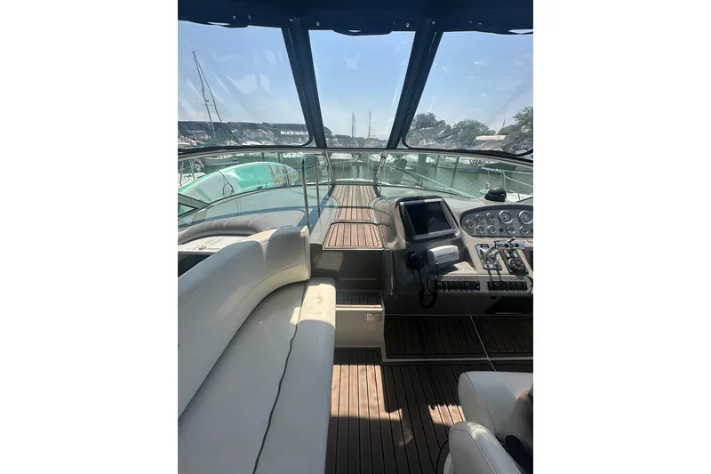 Slide: The Image of Interior view of 2006 Cruisers Yachts 370 Express, featuring helm and seating area. - 13