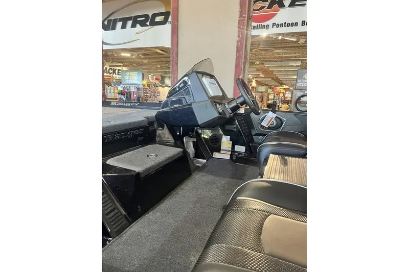 The Image of 2026 Ranger Z518 Cup-Equipped boat interior with steering console and seating. - 1