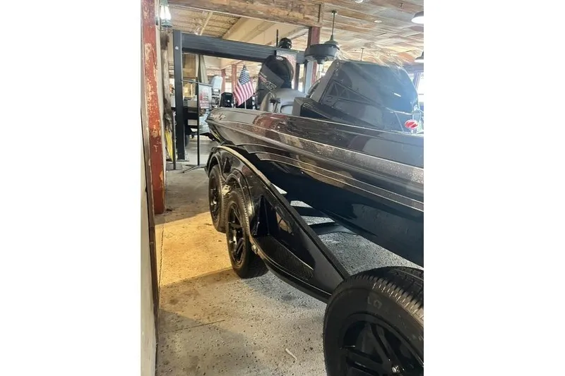 Slide: The Image of 2026 Ranger Z518 Cup-Equipped boat displayed indoors, showcasing sleek design and black finish. - 7