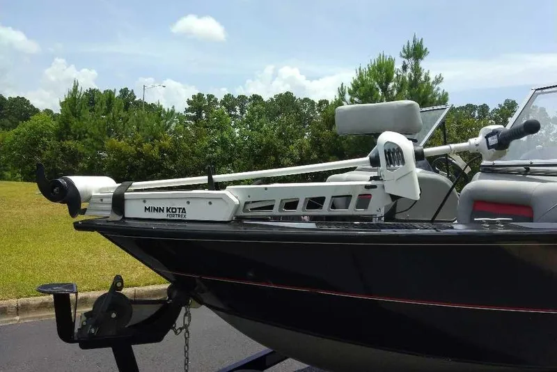 Slide: The Image of 2015 Tracker Targa V-18 WT boat with Minn Kota Fortrex motor, parked outdoors. - 5