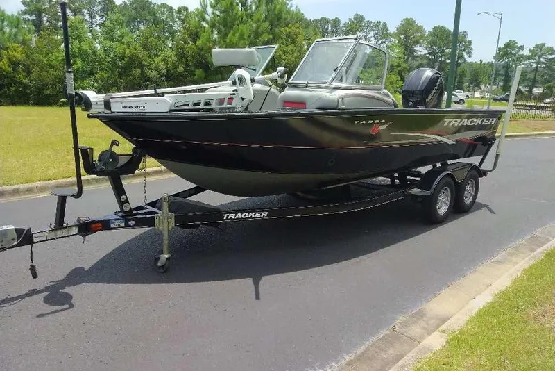 Slide: The Image of 2015 Tracker Targa V-18 WT boat on trailer, parked on a road. - 6