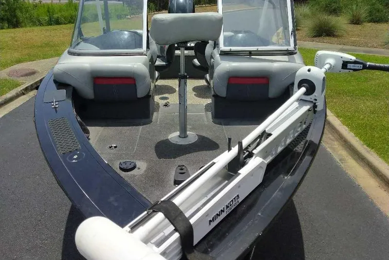 Slide: The Image of 2015 Tracker Targa V-18 WT boat with Minn Kota trolling motor on a paved surface. - 8
