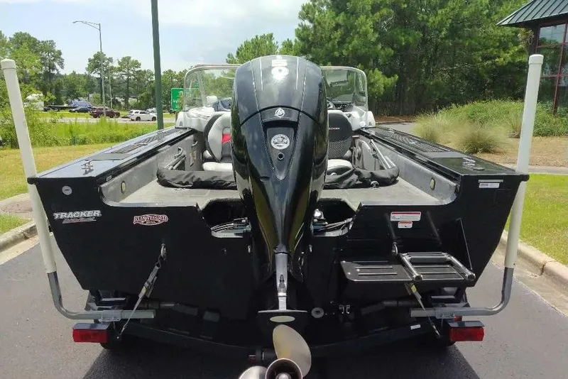 Slide: The Image of 2015 Tracker Targa V-18 WT boat with outboard motor, parked outdoors. - 11