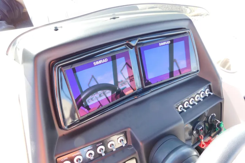 Slide: The Image of Dashboard of 2023 Viaggio Diamante U 26 with dual Simrad displays and control switches. - 21