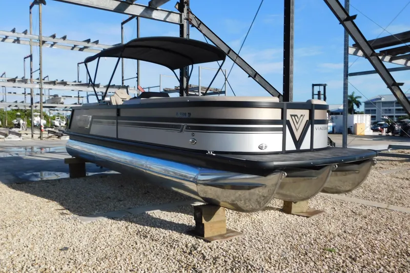 Slide: The Image of 2023 Viaggio Diamante U 26 pontoon boat on dry dock, under blue sky. - 3