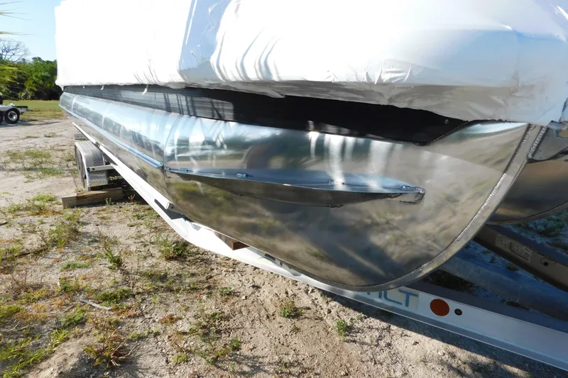 Slide: The Image of 2023 Viaggio Diamante U 26 pontoon boat on trailer, partially covered, outdoors. - 5