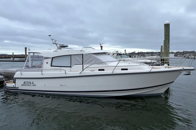 The Image of 2025 Nimbus 365 Coupe boat docked in Boston harbor under cloudy skies. - 0