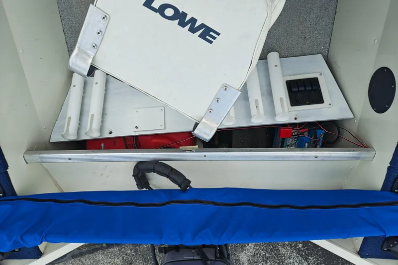 Slide: The Image of 1999 LOWE BOATS SEA NYMPH V-148SC interior with storage compartments and wiring. - 13