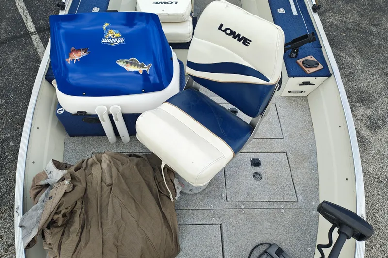 Slide: The Image of 1999 LOWE BOATS SEA NYMPH V-148SC interior with blue and white seating. - 10